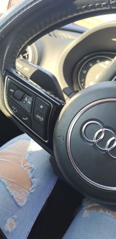 an audi steering wheel with the center console button on it's left hand side