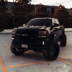 a black truck parked in a parking lot