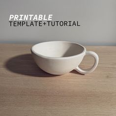 a white bowl sitting on top of a wooden table next to a cup with the words printable template