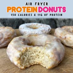 four glazed doughnuts sitting on top of a wooden cutting board with the words air fryer protein donuts 150 calories