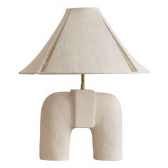 an elephant lamp with a beige shade on it