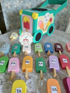 ice cream pops are arranged on a table with matching name tags and an ice cream truck