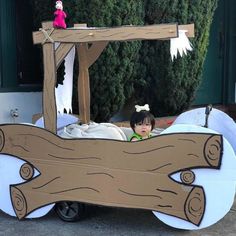 a child in a fake bed made to look like a horse and carriage with wood planks