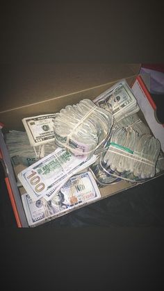 a box filled with lots of money sitting on top of a table