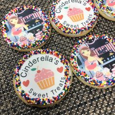 four decorated cookies sitting on top of a table