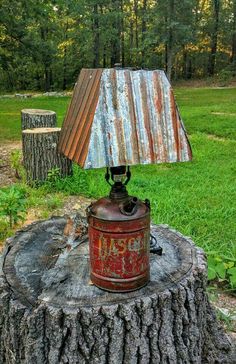 an old fashioned lamp is sitting on top of a tree stump