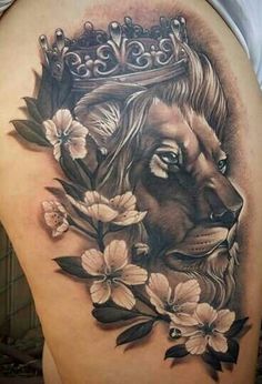 a woman's thigh with a lion and flowers on it