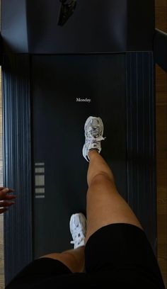 a person standing on top of a machine with their feet in the machine's position