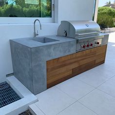 an outdoor kitchen with a sink and grill