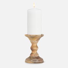 a wooden candle holder with a white candle