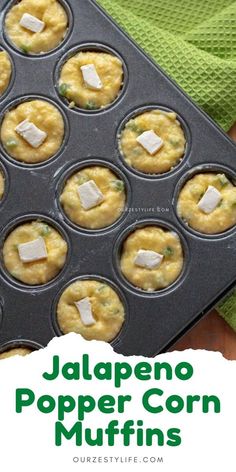 a muffin tin filled with cupcakes covered in cheese and green napkin next to it