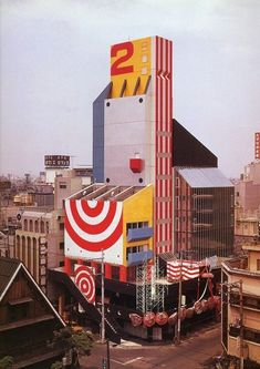 an aerial view of a city with buildings and large bulls eye sign on the building