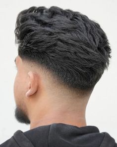 Imagine the ease of a hairstyle that looks effortlessly stylish. Here we see a modern tousle, an epitome of casual elegance. The hair is cut to a medium length on top, giving room for natural movement and flow. The sides are tapered neatly, creating a subtle contrast that's neither too stark nor too bland. This hairstyle is perfect for the man who balances professionalism with a laid-back attitude, making it an ideal choice for both the boardroom and the beach. Low Taper Comb Over, Taper Side Part Men, Low Taper Side Part, Side Part Taper Fade, Comb Over Taper Fade, Afro Hawk, Tapper Fade, Gentleman Haircut, Long Fade