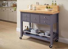 a kitchen island with two drawers and a cutting board on top