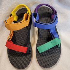 New Teva Women's Pride Sandal An Asymmetrical Update To The Classic Original Universal Pride Sandal, This Color-Blocked Remake Showcases Multi-Hued Straps That Vary From Left To Right. Grounded In A Colorful Outsole That Celebrates The Pride Flag And Its Call For Inclusivity, This Rainbow Sandal Straps Made From Recycled Plastic. Easy Hook-And-Loop Closure Comes On And Off Quickly And Gets The Fit Just Right. Molded Eva Midsole With Heel Cupping And Arch Cookie For Added Support Rubber Outsole F Adjustable Multicolor Sport Sandals For Summer, Multicolor Sport Sandals For Summer Outdoor, Multicolor Sandals For Summer Outdoor Activities, Multicolor Sandals For Outdoor Summer Activities, Multicolor Summer Sandals For Outdoor Activities, Casual Rainbow Synthetic Sandals, Casual Rainbow Open Toe Sandals, Casual Rainbow Sandals, Teva Original Universal