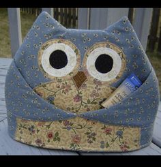 an owl purse is sitting on a table with a toothbrush in it's pocket