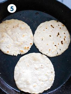 three tortillas are cooking in a skillet