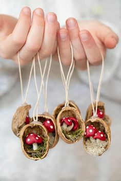 three small mushrooms are hanging from twine