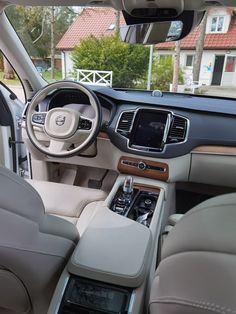 the interior of a car with beige leather seats and dashboards, including steering wheel