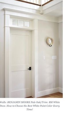 an open door in a room with white walls and wood flooring on the other side