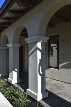 an outside view of a white building with arches