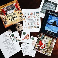 several christmas cards are laid out on a table with some type of book in the background