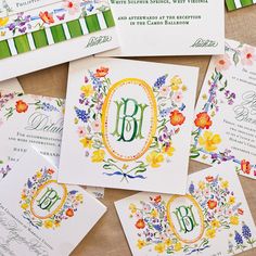 the wedding stationery is decorated with flowers and monogrammed cards