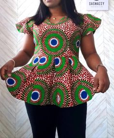 Introducing our stunning and vibrant African Print Peplum Top, a true celebration of cultural heritage and contemporary fashion. This Ankara-inspired masterpiece exudes elegance and style, making it the perfect addition to any woman's wardrobe. With its unique blend of traditional African motifs and modern design, this flared top promises to be show-stopping piece that will turn heads wherever you go.  Crafted with care and precision, this African print top is made from high-quality, breathable Kitenge Shirts Women, Kitenge Top Designs For Ladies, African Peplum Top Outfits, African Blouses Peplum Tops With Jeans, Sowing Designs, African Peplum Top, Peplum Kitenge Top, African Motifs, Night Angel