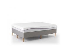 an image of a mattress with no sheets on it, in front of a white background