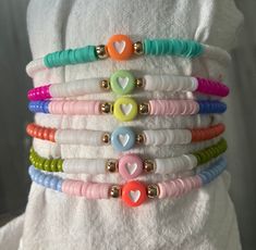 ALL BRACELETS ARE SOLD INDIVIDUALLY   These colorful  personalized bracelets are perfect to add to any bracelet set that you might have or even to wear by themselves. They are made up of colorful glass and heishi beads.  HEART BEADS: purple, blue, green, pink, yellow, red, orange  SIDE HEISHI BEADS: if one is not picked, i'll bead white on the sides  PRODUCT DETAILS  Bracelets are strung on high quality stretchy cord.Easy to roll on your hand and take off.  -Closure:tie LENGTH:  You can referenc Cheap White Wristband With Colorful Beads, Cheap White Braided Bracelet With Colorful Beads, Bracelet Keychains, Tie Length, Bachelorette Party Favors, Bracelets Handmade Beaded, Stretchy Bracelets, Heishi Beads, Personalized Bracelets