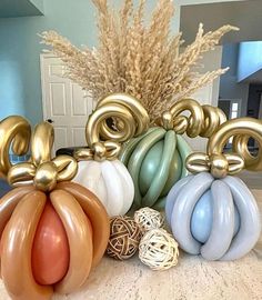 there are many balloons in the shape of pumpkins and other items on the table