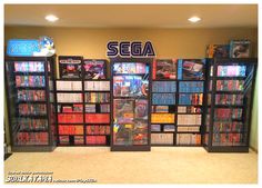 several video games are on display in front of the sign for sega, which is located