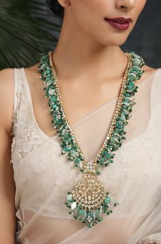 Green Kundan Inspired Necklace .This beautifully handcrafted necklace is set in silver and copper alloy and plated with 22k gold. This necklace with a twist of Pearl stones by Paisley Pop is a perfect accessory for an Indian Bride. Necklace Size - Length 36 inc, Width 1.5 inc Closure - Adjustable Thread Dori Style Tip - Wear this with almost anything Indian for a rich and royal look because nothing more regal than kundan necklace set. We love teaming this with classy chiffon sarees or zari silk Luxury Kundan Necklace With Zari Work For Designer Wear, Luxury Festive Kundan Necklace With Emerald, Luxury Spiritual Kundan Necklace With Gemstones, Luxury Kundan Jewelry With Dangling Beads, Luxury Kundan Necklace With Peacock Design For Festive Season, Luxury Kundan Gemstone Necklace For Party, Luxury Festive Kundan Necklace With Peacock Design, Luxury Green Kundan Necklace For Designer Wear, Luxury Silver Kundan Necklace With Meenakari