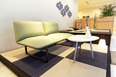 a couch and table in an office lobby