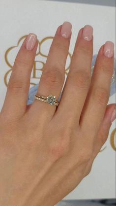 a woman's hand with a diamond ring on it