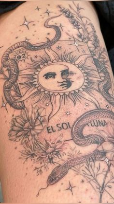 a woman's arm with tattoos on it that says el sol luna and two snakes