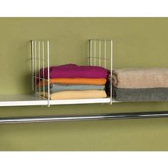 a metal shelf with towels and blankets on it