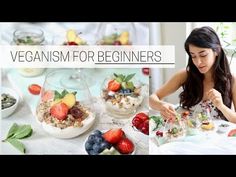 a woman sitting at a table with fruit and yogurt