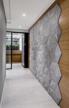 a modern hallway with wood paneling and white carpeted flooring, along with an abstract wall design