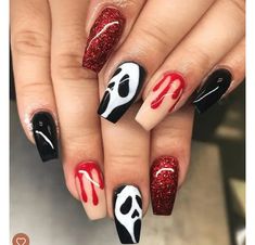 someone has painted their nails with red and white paint on them, while the nail is black