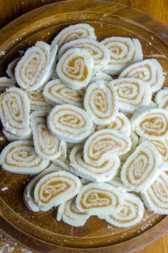 some kind of food that is on a wooden platter and ready to be eaten