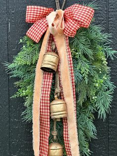 a christmas wreath with bells hanging from it