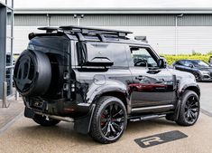 a black land rover parked in front of a building