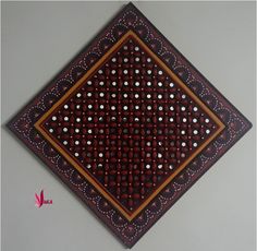 a decorative wall hanging made out of wood with dots on the top and bottom half