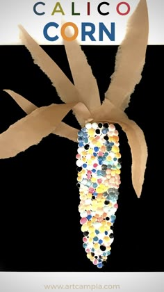 a corn on the cob is made out of paper and some colored confetti