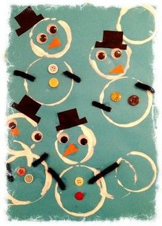 a group of snowmen made out of buttons on a piece of blue paper with black top hats