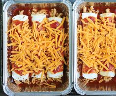 two plastic containers filled with food covered in cheese