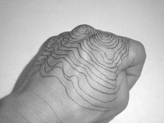 a black and white photo of a person's hand with lines drawn on it