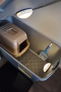 the inside of an airplane with a cat carrier and litter box