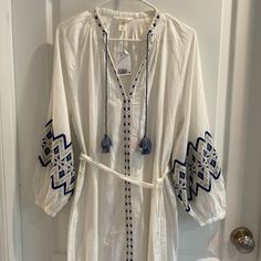 Beautiful White And Blue Embroidered Kaftan Dress By H & M Nwt Size Xs Has Balloon Style Sleeves With Button At End Small Side Slits Total Length 48” Under Arm Across Front 23” Belt Is Removable H&m Bohemian Long Sleeve Dresses, H&m Long Sleeve Cotton Dresses, H&m Bohemian V-neck Dress, H&m Bohemian Spring Dresses, White H&m Beach Dress, White H&m Dress For Beach, H&m Blue Beach Dress, White Cotton H&m Dresses, H&m White Long Sleeve Dresses